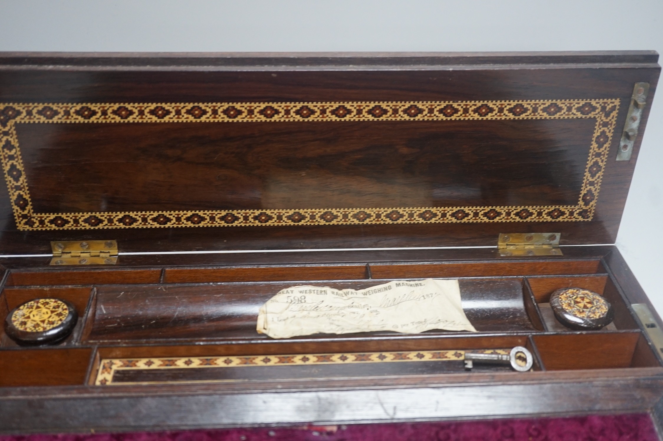 A Victorian Tunbridge ware rosewood writing slope, decorated with a tesserae mosaic view of Hever Castle, 39cm wide, with mosaic inlaid interior and covers to the glass inkwells.